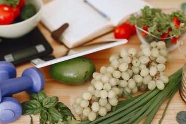 A vibrant composition of fruits, vegetables, and fitness items promoting a healthy lifestyle.